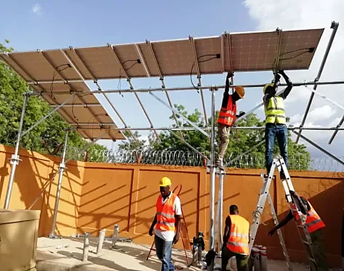 Techniciens TENERGY installant une structure solaire sur un site sécurisé